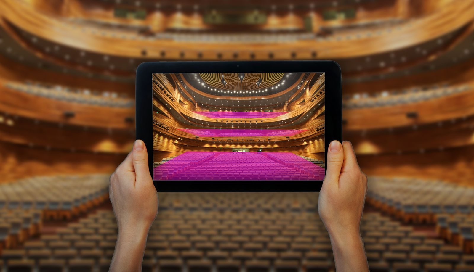 A designer controlling coverage from an iPad in augmented reality inside a theatre